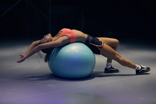 woman stretch over ball